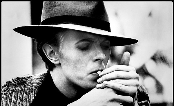 David Bowie photographed by Geoff MacCormack lighting up a Gitane cigarette in 1975