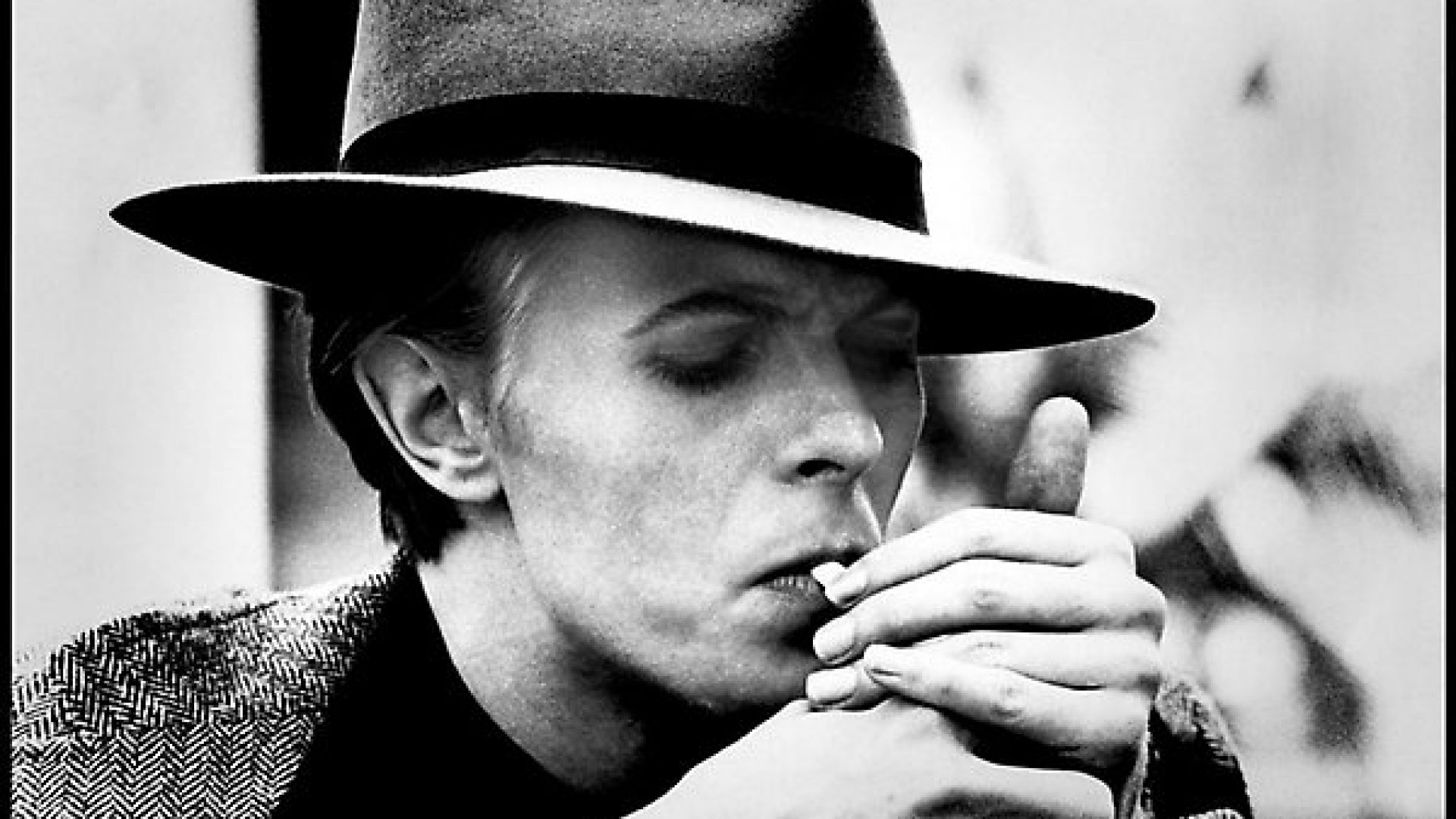 David Bowie photographed by Geoff MacCormack lighting up a Gitane cigarette in 1975