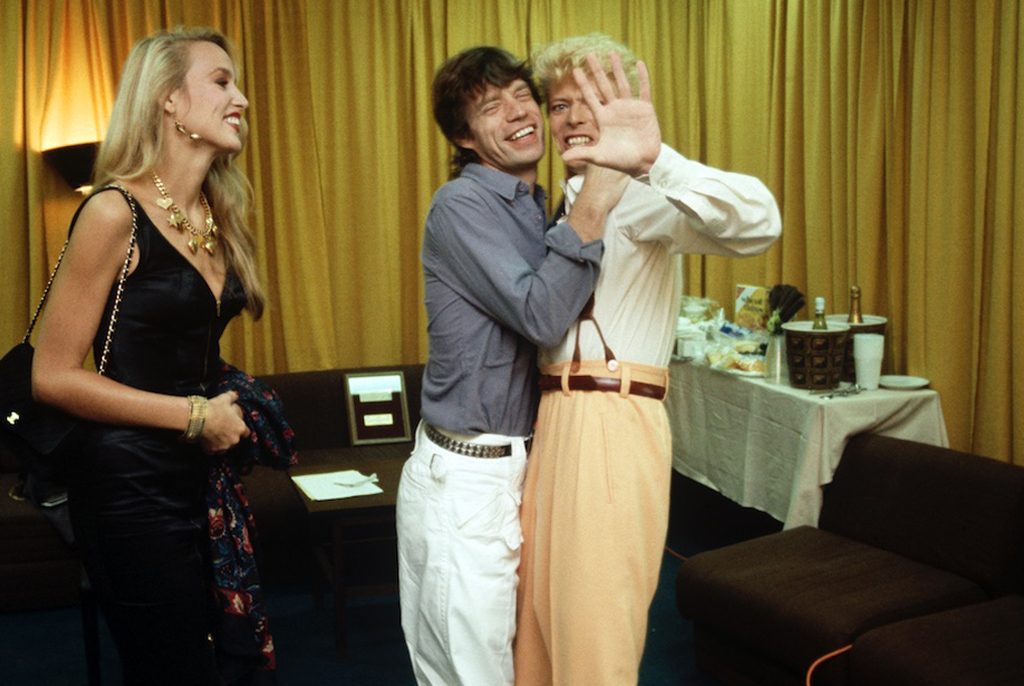 David Bowie, Jerry Hall and Mick Jagger photographed by Denis O'Regan in 1983 © Denis O’Regan